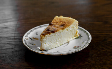 Cheesecake on a plate on a wooden table