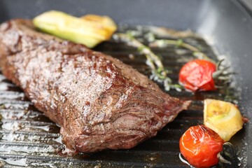 Delicious grilled beef meat and vegetables in pan, closeup