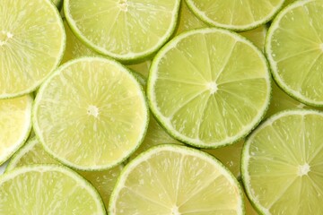 Fresh juicy lime slices as background, top view