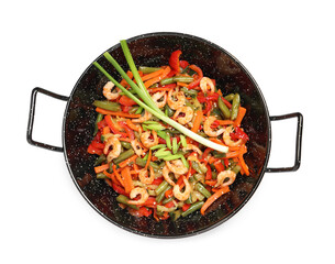 Shrimp stir fry with vegetables in wok on white background, top view