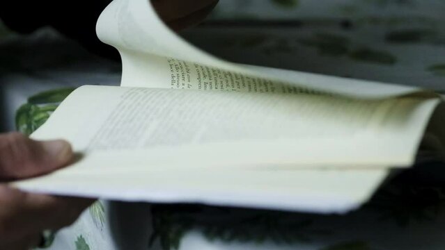 turning page of book in slow motion woman senior hand