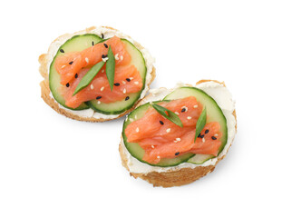 Tasty canapes with salmon, cucumber and cream cheese isolated on white, top view