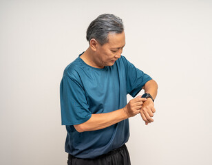 Senior old man wearing sportswear using Smart Watch Showing Heart Rate Monitor on isolated...