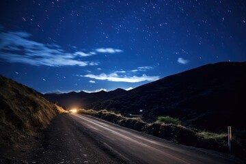 Fototapeta premium Mountain road with a starry sky above.