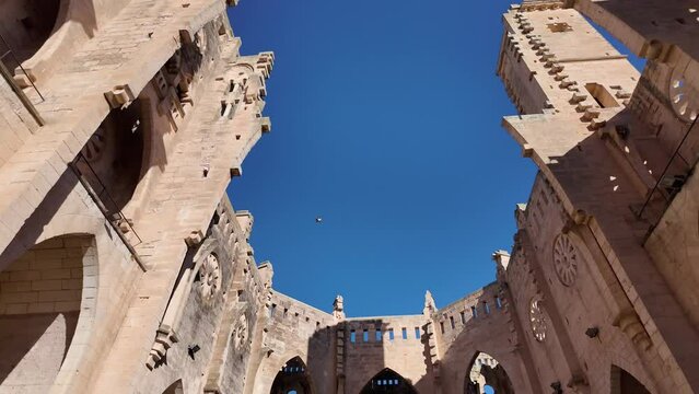 Architectural marvel in Son Servera, never finished church by Joan Rubio (Gaudi's assistant) Mallorca, Spain. Looking up towards blue sky