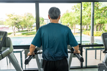 Senior old man runner exercise indoor gym. fitness man jogging wearing sportswear. Mature athlete...