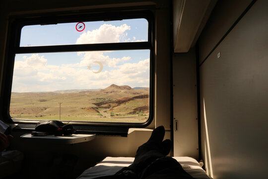 The view out of a window from the bed in the sleeping compartment, on the train ride in the Eastern Express, Dogu Ekspresi from Kars to Ankara, relaxing while watching the landscape, Turkey