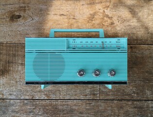 vintage transistor radio circa 1960s wooden wall background