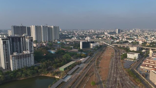 A dynamic drone footage capturing the essence of Chennai's urban landscape, from the busy city center to the tranquil suburban areas, all under a cloudy sky.