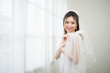 Beautiful asian bride with fashion wedding hairstyle and makeup. Portrait of young gorgeous bride...