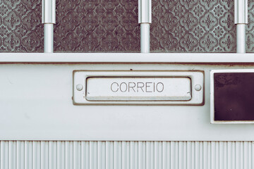 View on mailbox integrated in a metal door. Inscription correio in Portuguese