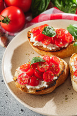 delicious Italian bruschetta with tomatoes on a light stone background