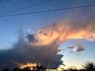 Sunset sky with clouds over residential houses