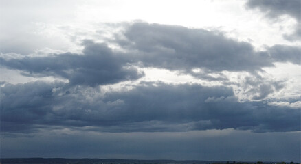 Emmett sunsets in vast field under cloudy sky