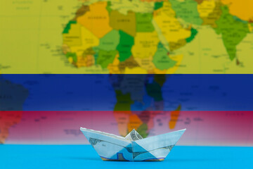 Sea transport of Colombia concept, bulk carrier or ships on sea, paper ship with Colombia flag
