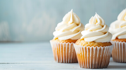 Vanilla Cupcakes with Creamy Frosting. Close-up of vanilla cupcakes topped with swirls of creamy white frosting, set against a soft blue background. AI generative.