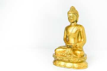 A golden statue of a Buddhist figure meditating facing the side isolated on white background. Bodhisattva Face. Concept for Vesak Day and Enlightenment Day