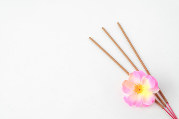 Isolated Empty white background decorated with colorful flowers and incense. Concept for Vesak Day and Enlightenment Day. Empty blank copy text space