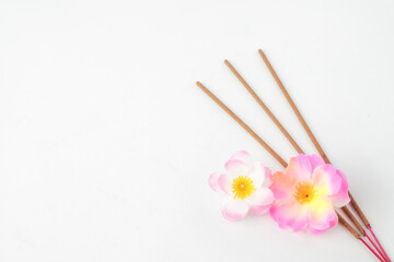 Isolated Empty white background decorated with colorful flowers and incense. Concept for Vesak Day...