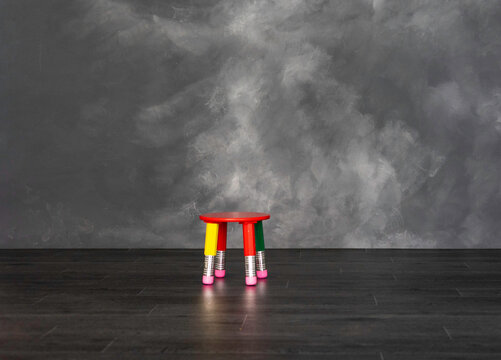 taburete de colores en sala gris oscuro