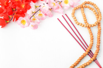 Isolated Empty white background decorated with colorful flowers, red colored incense and prayer...