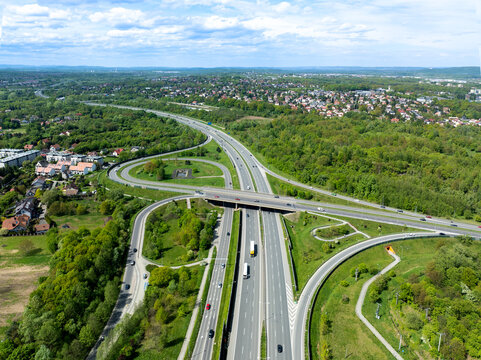 Krakow, Poland. Highway multilevel spaghetti junction on A4 international three lane motorway, the part of freeway around Cracow with local highway. Aerial view in spring