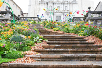 the Girona church stairs with a colorful flower garden. Flowers festival in may