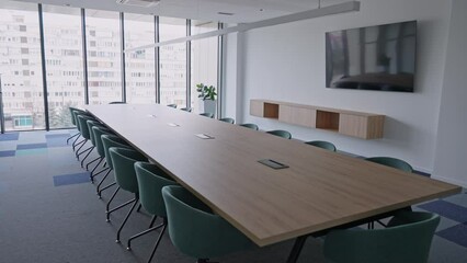 Modern Conference Room with Chairs, Table and TV. Corporate boardroom interior with minimalist design. Comfortable seating in a contemporary workspace