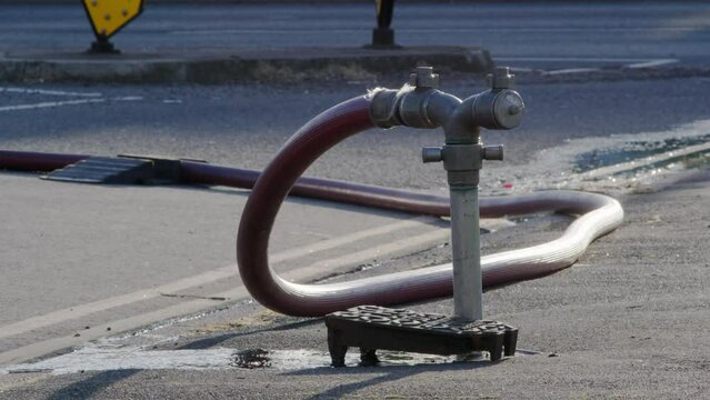 A well in a street has been opened and a fire hydrant connection point to supply water on road in england uk.