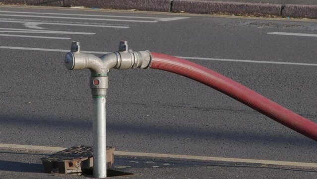 A well in a street has been opened and a fire hydrant connection point to supply water on road in england uk.