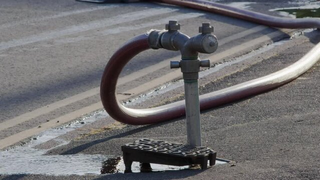 A well in a street has been opened and a fire hydrant connection point to supply water on road in england uk.