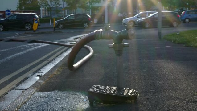 A well in a street has been opened and a fire hydrant connection point to supply water on road in england uk.