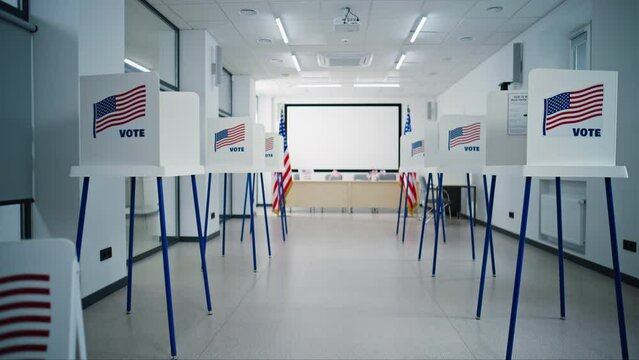 Voting booths with American flag logo in bright polling station office. National Election Day in the United States of America. Political races of US presidential candidates. Concept of democracy.