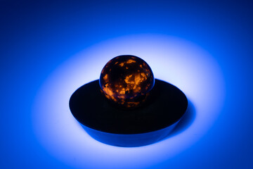 natural yooperlite gem stone in uv light on the white background