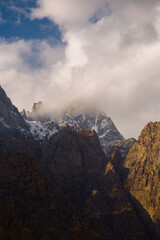 Clouds drifting over rugged snow dusted mountain peaks © sbjshah
