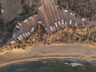 Many motor homes and camper vans parked at beautiful beach Playa la Carolina aerial view