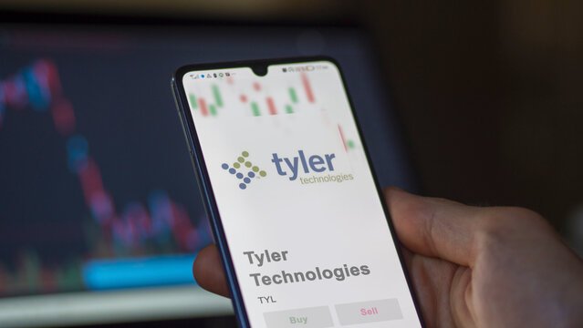 April 09th 2024 , Plano, Texas. Close up on logo of Tyler Technologies on the screen of an exchange. Tyler Technologies price stocks, $TYL on a device.