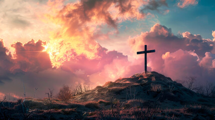 A cross is on top of a hill in a field with a beautiful sunset in the background