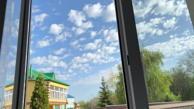 Hand is slowly reaching out to open and reveal window as sun shines through. Woman opens a window with the view. Symbol of hope positivity new energy and ideas vision