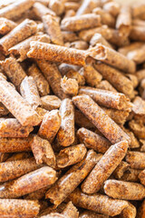 Fototapeta premium selective focus, wood sawdust pellets for wood stoves, ecological biofuel