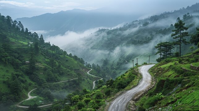 Cloudy sky and curve of Himalayan road, monsoon landscape of Garhwal, Uttarakhand, India. Climate change effect on Himalays bringing landslide, untimely rain and destruction of mountain environment.