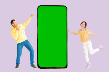 Full body fun young couple two friends family man woman wear casual clothes together point hands on big huge blank screen mobile cell phone with area isolated on pastel plain light purple background