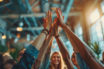 A group of individuals cheerfully giving each other high fives in a collaborative and celebratory atmosphere