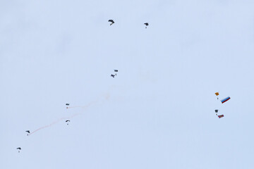 Airborne forces paratroopers soaring holding Flag of Russia and flags of military units, military...