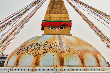 Boudhanath stupa in Kathmandu, Nepal decorated Buddha wisdom eyes and prayer flags, most popular...