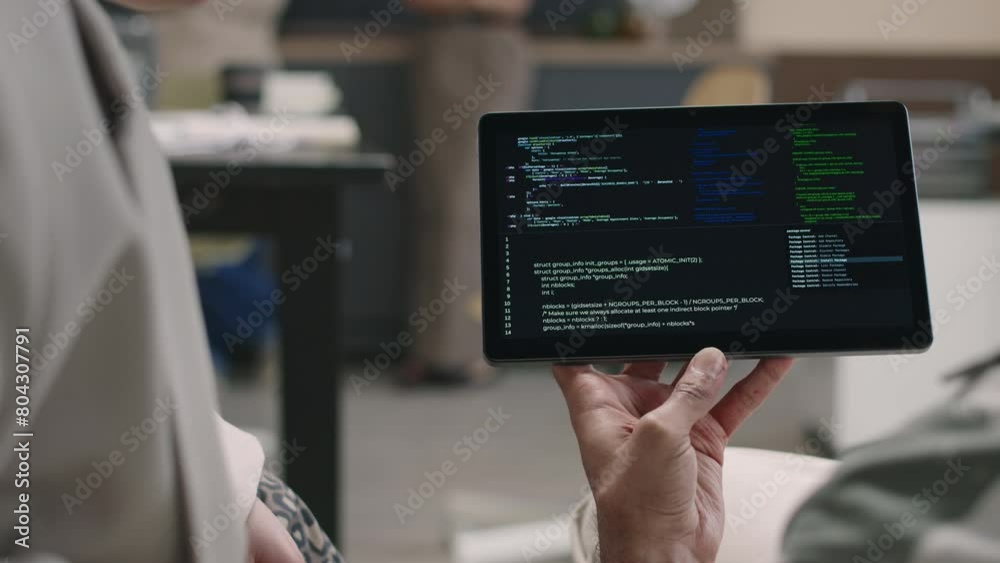 Wall mural closeup of two unrecognizable office program developers looking at digital tablet with codes running