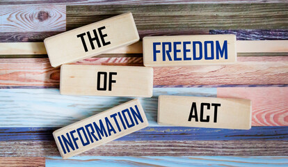 Business concept. On a vintage background, wooden blocks with the inscription - The Freedom of...