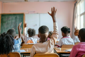 boy raising hand while answering in class at elementary school