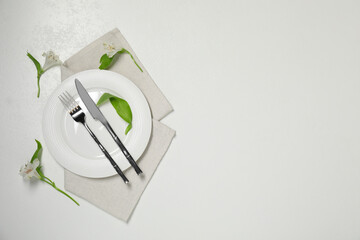 Stylish setting with elegant cutlery on white table, top view. Space for text
