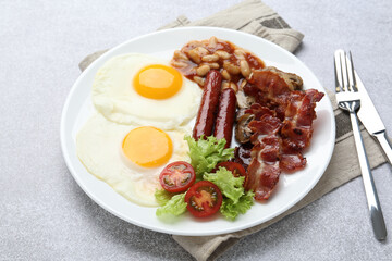 Delicious breakfast with sunny side up eggs on light table